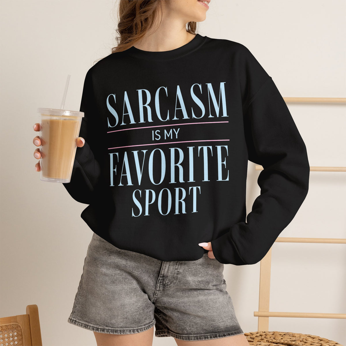 Black sweatshirt with Sarcasm Is My Favorite Sport quote printed on front.